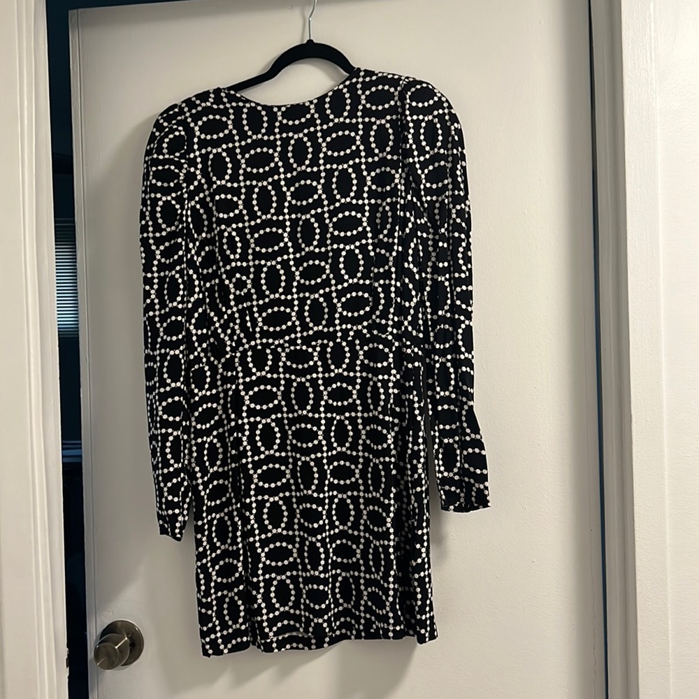 Padded shoulder open back dress.